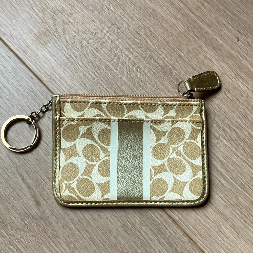 Coach Gold tone Card Wallet with lilac lining.